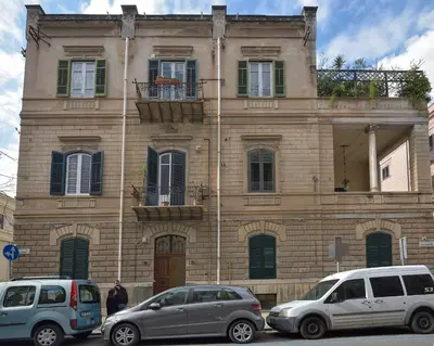 two cars parked in front of a building at Palazzo Gregorietti Boutique Apartments in Palermo