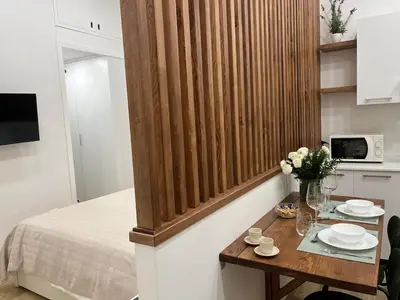 a small room with a bed and a table with flowers at A Casa di Chiara in Palermo