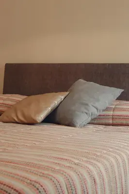 a bed with two pillows on top of it at Casa del Gelso Tra Palermo e Cefalù in Trabia