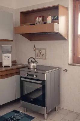 a kitchen with a stove with a tea kettle on it at Casa del Gelso Tra Palermo e Cefalù in Trabia