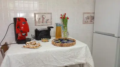 a table with a white table cloth with food and a blender at Casa del Gelso Tra Palermo e Cefalù in Trabia