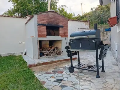 a barbecue grill in front of a brick oven at Casa del Gelso Tra Palermo e Cefalù in Trabia