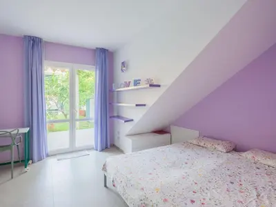 a bedroom with purple walls and a bed and a window at CasaSol - Live Your Sol in Alcamo