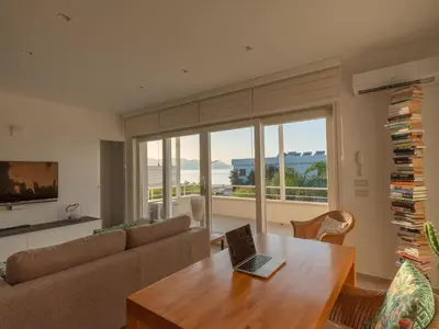 a living room with a couch and a table with a laptop at CasaSol - Live Your Sol in Alcamo