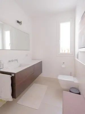 a white bathroom with a sink and a toilet at CasaSol - Live Your Sol in Alcamo