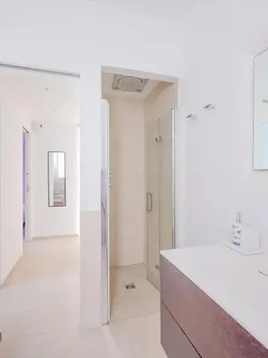 a bathroom with white walls and a white counter at CasaSol - Live Your Sol in Alcamo
