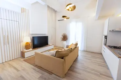 a living room with a couch and a tv at Dimora Blanca in Bagheria