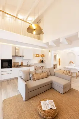 a living room with a couch and a kitchen at Dimora Blanca in Bagheria