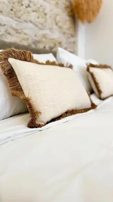 a bed with white sheets and pillows on it at Dimora Blanca in Bagheria