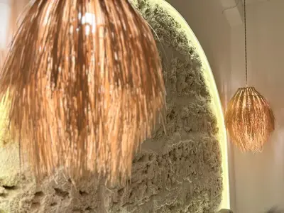 a light hanging from a surfboard on a wall at Dimora Blanca in Bagheria