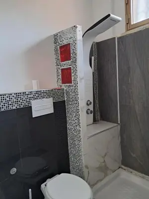 a bathroom with a toilet and a shower at House victor in Palermo
