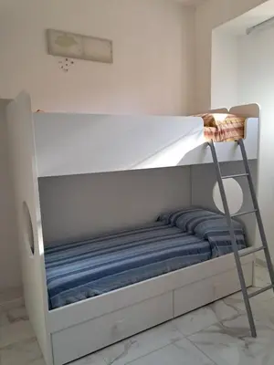 a bunk bed with a ladder in a room at House victor in Palermo