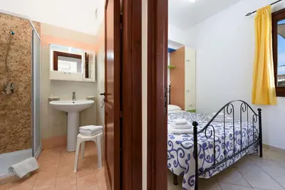 a bathroom with a shower and a toilet and a sink at Trilocale 4 moderno con patio a San Vito Lo Capo in San Vito lo Capo
