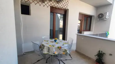 a table and chairs in a room with a table at utveggio view apartment in Palermo