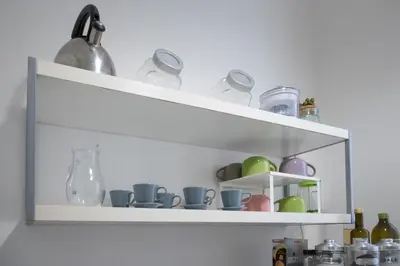 a white shelf with cups and vases on it at Casa Soliva al Centro di Palermo in Palermo