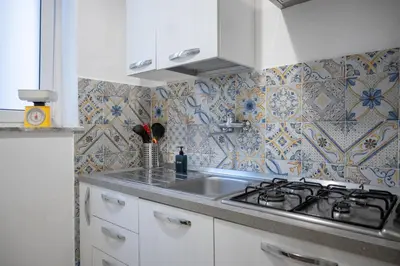 a kitchen with a sink and a stove at Casa Soliva al Centro di Palermo in Palermo