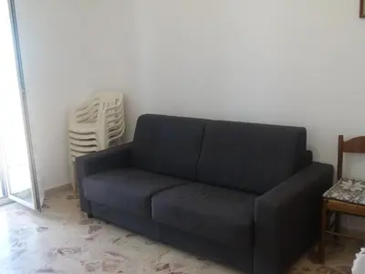 a black couch sitting in a living room at Casa di Laura - Aspra vista mare in Bagheria