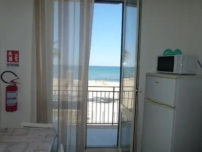 a room with a balcony with a view of the beach at Casa di Laura - Aspra vista mare in Bagheria