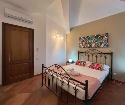 a bathroom with a sink and a tub and a toilet at Villa Oxidiana with pool and garden in Campofelice di Roccella