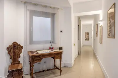 a hallway with a wooden table and a window at Bella Vista nel centro storico in Palermo