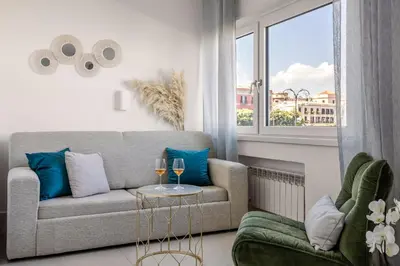 a bedroom with a large white bed with a mirror at Bella Vista nel centro storico in Palermo