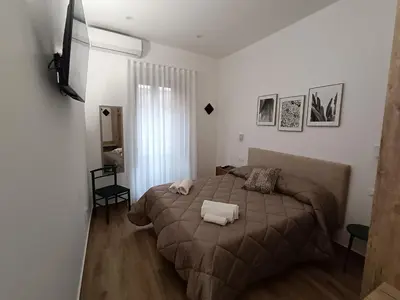 a bedroom with a bed with two pillows on it at Calderai 52 Apartments in Palermo