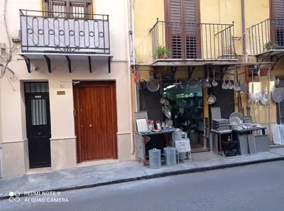 a store on the side of a building with a door at Calderai 52 Apartments in Palermo