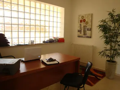 an office with a desk with a laptop and a chair at Appartamenti Campo in Trappeto