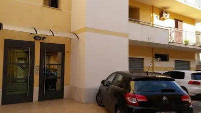 a car parked in front of a building at Appartamenti Campo in Trappeto
