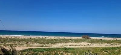 a sandy beach with the ocean in the background at Arancina Abbronzata in Balestrate