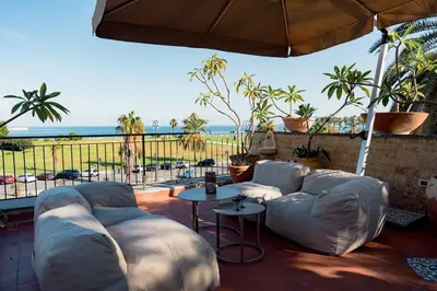 a living room with a couch and a view of the ocean at La Casena del Principe in Palermo