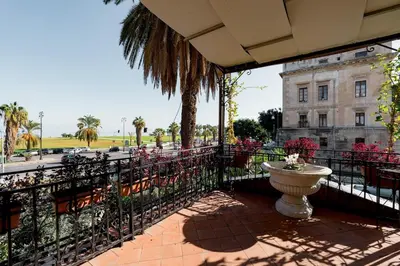 a balcony with a fountain in front of a building at La Casena del Principe in Palermo