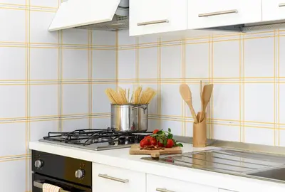 a kitchen with a stove with a cutting board with vegetables at Bilocale Piano Terra a 400 mt dal mare in San Vito lo Capo