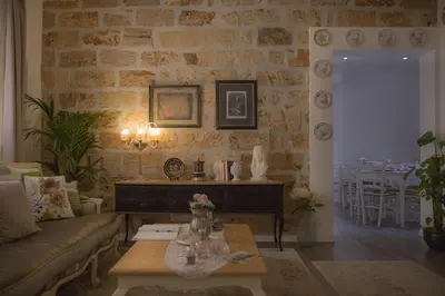 a living room with a couch and a table at TAM Vacanze B&B in Cinisi
