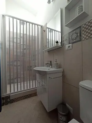 a bathroom with a sink and a large window at Gioia Guesthouse in Alcamo