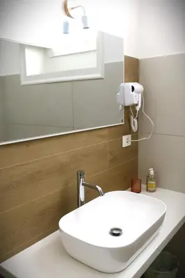 a bedroom with a bed and a desk and a television at C'era una Volta a Palermo in Palermo