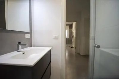 a bathroom with a sink and a mirror and a hallway at Casa Pisani 274 in Palermo
