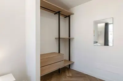 a dressing room with a mirror and a wooden dresser at GuestHost - Hamuri Holiday House - Heart of Palermo in Palermo