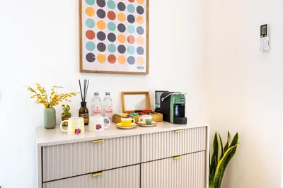 a dresser with a coffee maker and cups on it at Appartamenti Pellegrino Centro in Palermo