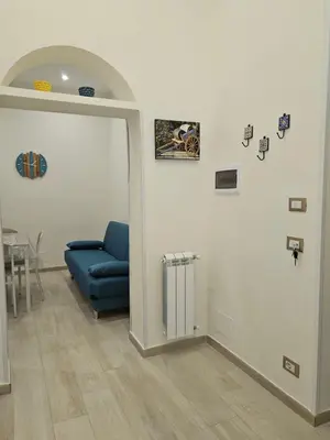 a living room with a blue couch and a table at Casa Amato appartamento alla zisa in Palermo