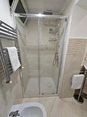 a bathroom with a shower with a toilet and a sink at Casa Amato appartamento alla zisa in Palermo