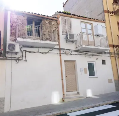 a white building with two balconies and a door at Sweet Home Pioppo in Pioppo