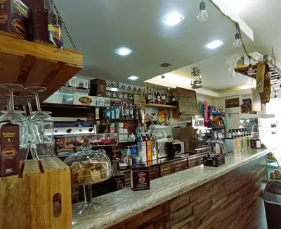 a bar with a counter with a lot of alcohol at Sweet Home Pioppo in Pioppo