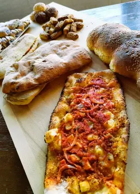 a cutting board with a slice of pizza and bread at Sweet Home Pioppo in Pioppo