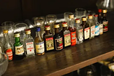 a row of bottles of alcohol on a table with glasses at Sweet Home Pioppo in Pioppo