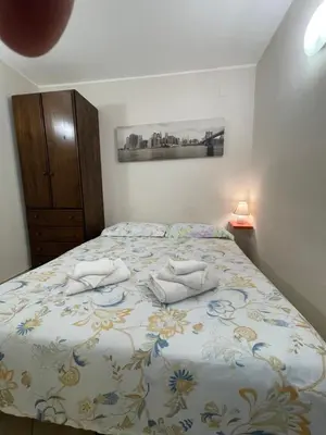 a bedroom with a bed with two towels on it at Norman City House in Palermo