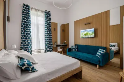 a bedroom with a bed and a blue couch at Casa Palermo in Palermo
