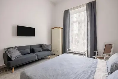 a living room with a bed and a couch at Casa Palermo in Palermo