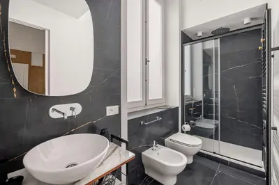a bathroom with a sink and a toilet and a mirror at Casa Palermo in Palermo