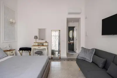 a living room with a bed and a couch at Casa Palermo in Palermo